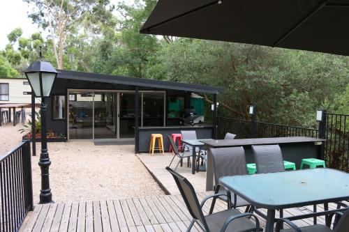 a group of tables and chairs on a deck at Adelaide Brownhill Creek Tourist Park in Adelaide