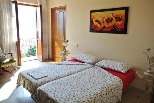 a bedroom with a bed and a painting on the wall at Casa Farfalla in Cannobio
