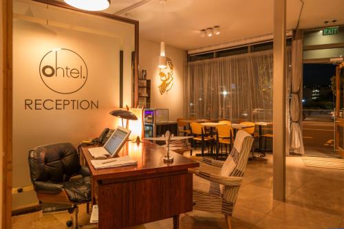 a office with a desk with a laptop on it at Ohtel Wellington in Wellington