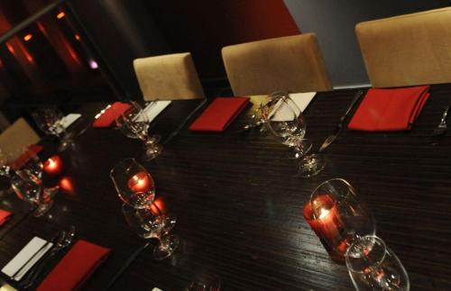 a black table with wine glasses and red napkins at Executive Hotel Cosmopolitan Toronto in Toronto