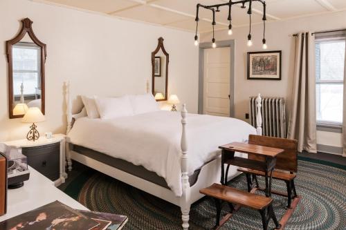 a bedroom with a bed and a table and a chair at The Deers Head Inn Tavern in Elizabethtown