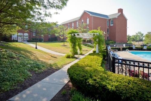 a walkway in front of a building with a pool at Nationwide Hotel and Conference Center in Lewis Center