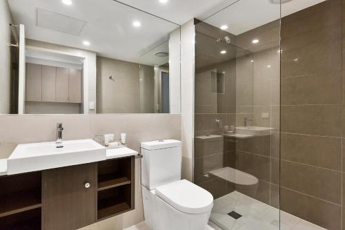 a bathroom with a toilet and a sink and a shower at Quality Hotel Manor in Mitcham