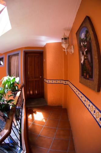 a staircase in a house with orange walls at Hotel posada casa regia in Xalapa