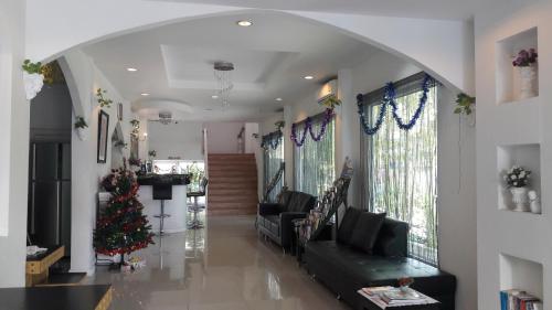 a living room with a christmas tree in the middle at Jasmine Chiangmai Boutique Hotel in Chiang Mai