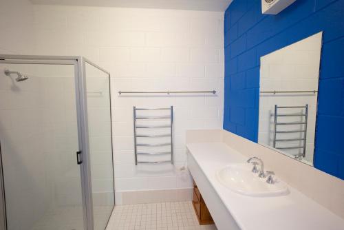 a bathroom with a sink, toilet and shower stall at Thredbo YHA in Thredbo
