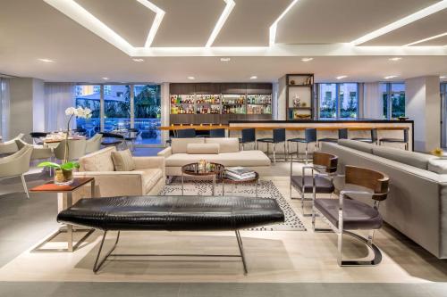 a living room with couches and a bar at Hyatt Centric South Beach Miami in Miami Beach