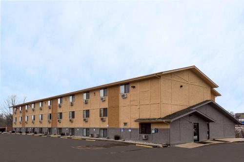 a large brown building with a sky in the background at Super 8 by Wyndham Dubuque in Dubuque