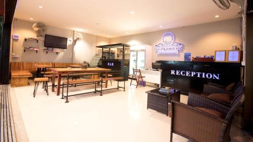 a restaurant with a table and chairs in a room at AVA Boutique Guesthouse in Koh Tao