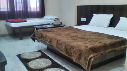 a bedroom with a large bed and a table at Laxmi Mahal in Udaipur