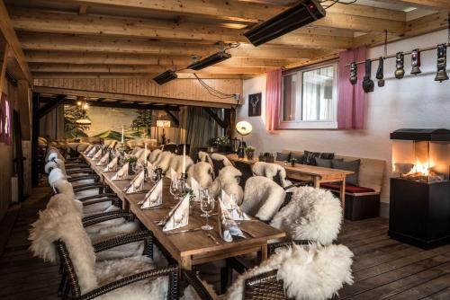 a long table in a room with white chairs and tables at Landgasthof Ochsen in Sinzheim