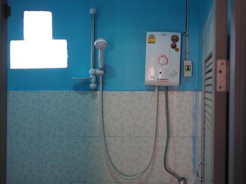 a shower in a bathroom with a blue wall at Kaokondo resort in Sangkhla Buri