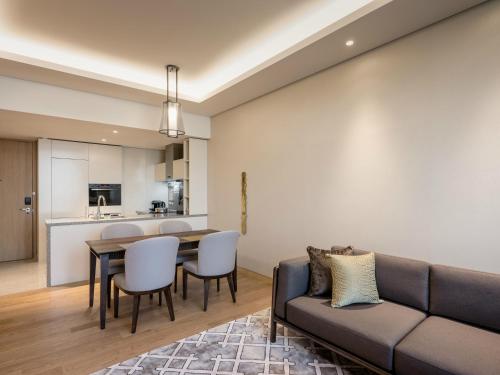 a living room with a couch and a table at Grand Mercure Ambassador Hotel and Residences Seoul Yongsan in Seoul