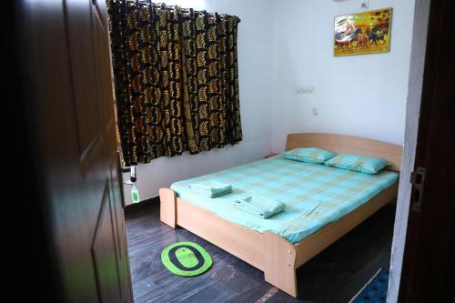 a small bed in a room with a window at CBR Ayurhealth in Kannur