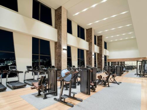 a gym with treadmills and exercise equipment in a building at Grand Mercure Ambassador Hotel and Residences Seoul Yongsan in Seoul