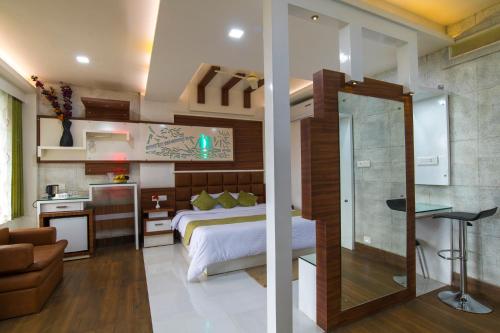two images of a bedroom with a bed and a bathroom at Olives The Boutique Resort in Kalpetta