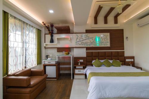 a hotel room with two beds and a couch at Olives The Boutique Resort in Kalpetta