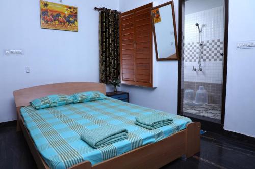 a bedroom with a bed with pillows and a shower at CBR Ayurhealth in Kannur