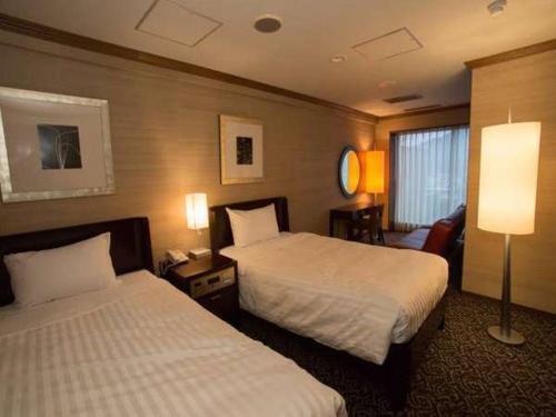 Кровать или кровати в номере Atami Season Hotel