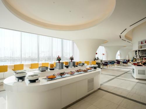 a large room with a buffet of food at ibis Styles Ambassador Seoul Yongsan in Seoul