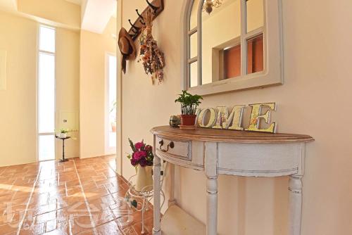 a room with a table with a mirror and some flowers at 夏日澄藍The Charming Land in Baisha