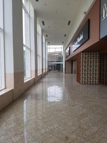 an empty hallway of a shopping mall with a sign at Taj Santacruz in Mumbai