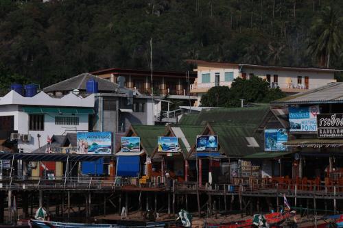 a group of buildings and houses with signs on them at AVA Boutique Guesthouse in Koh Tao