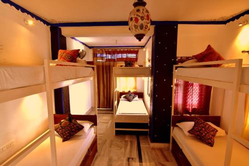 a dorm room with four bunk beds in it at Yogis Guest House in Jodhpur
