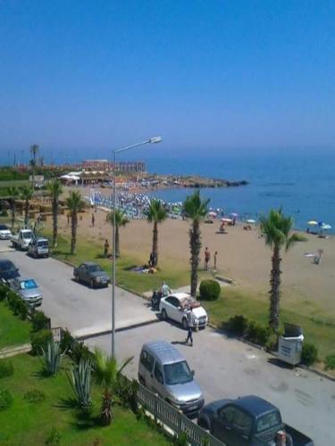 a parking lot next to a beach with cars parked at Esperanza Hotel in Antalya