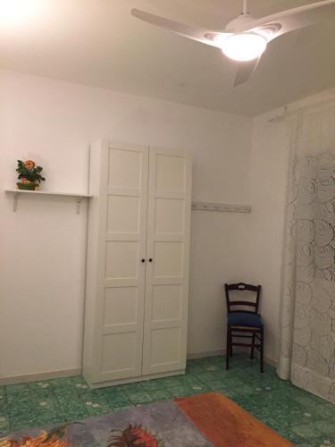 a room with a white door and a chair at Villa Feltran in Forte dei Marmi