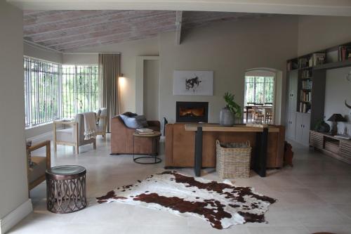 a living room with a couch and a fireplace at Amberhall Guesthouse in Johannesburg