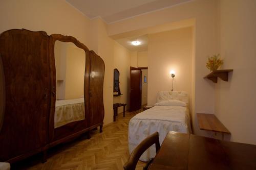a room with a bedroom with a bed and a mirror at Casa Ferrari Bed & Breakfast in Sofia