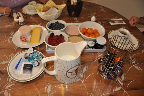 a table topped with plates and bowls of food at Hirschfarm, Goldau in Goldau