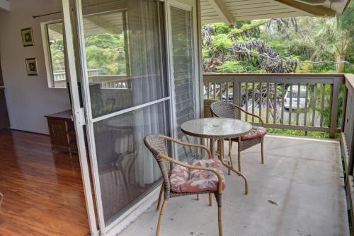 a patio with a table and chairs on a porch at Kihei Bay Surf 233 in Kihei