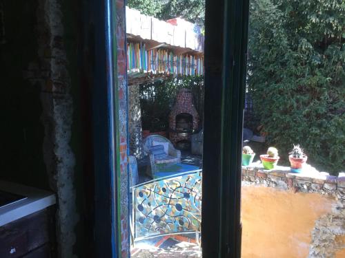 a window with a view of a garden with a patio at Casa toscana in Thun