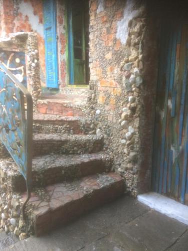 a stone building with stairs leading to a door at Casa toscana in Thun