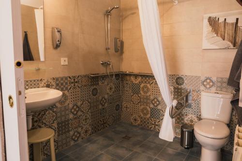 a bathroom with a toilet and a sink at Makala apartamentuak in Zarautz