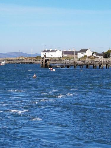 a large body of blue water with a dock at Greencastle B&B in Kilkeel