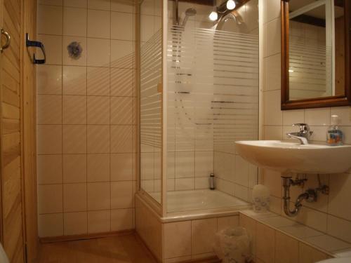 a bathroom with a shower and a sink and a tub at Gasthaus Alte Brauerei in Ettenheim