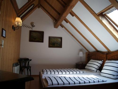 a bedroom with two beds in a attic at Gasthaus Alte Brauerei in Ettenheim