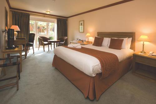 A bed or beds in a room at Kings Lynn Knights Hill Hotel & Spa, BW Signature Collection