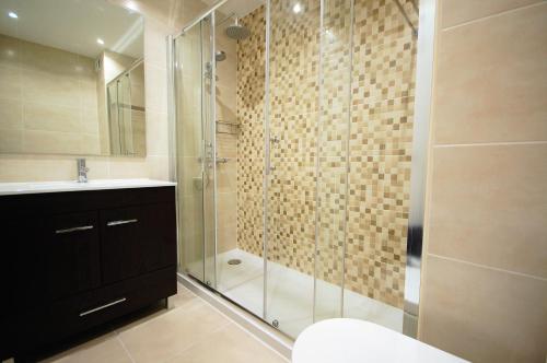 a bathroom with a shower and a toilet and a sink at Apartamento Velamar - 250 m from the Beach by Bedzy in Albufeira