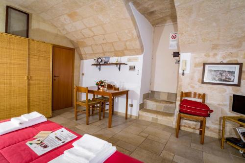 a bedroom with a bed and a table and chairs at B&B Borgo San Martino in Monopoli