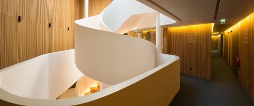 a white staircase in a room with wooden walls at Evora Olive Hotel in Évora