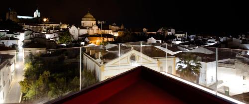 a view from the roof of a building at night at Evora Olive Hotel in Évora