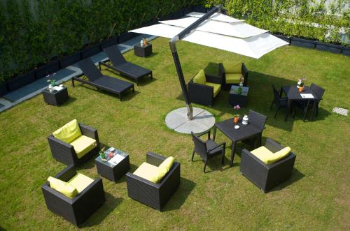 an overhead view of chairs and tables and an umbrella at Acca Palace AA Hotels in Milan