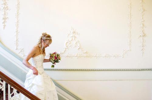 a bride walking down the stairs at her wedding at The Eagle House Hotel in Launceston