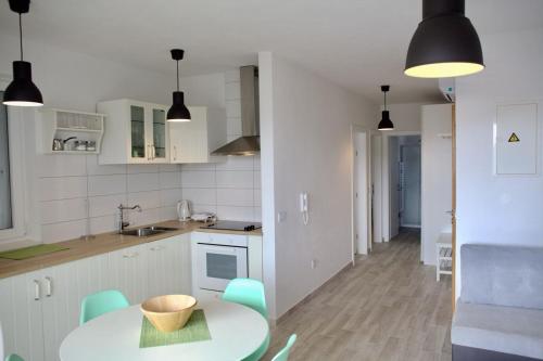 a kitchen and dining room with a table and chairs at Olive place in Tisno