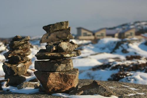 a stack of rocks sitting on top of a snow covered field at Hav & Logi Skärhamn in Skärhamn