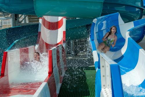 a woman on a water slide at a water park at Leonardo Club Hotel Dead Sea - All Inclusive in Ein Bokek